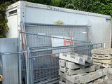 a large pile of concrete blocks in front of a fence