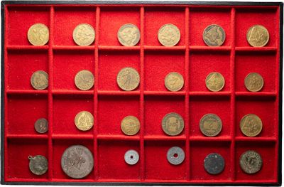 an image of a red display case filled with lots of coins