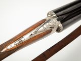 a close up of a bow with a wooden handle and a metal handle