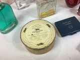many different perfumes on a white table with a blue box