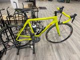 a yellow bike that is sitting on a stand