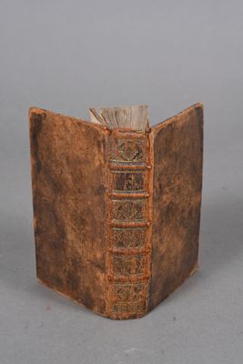 an old book that is open on a table