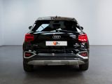 the rear end of a black audi suv parked in a white room