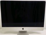 a computer monitor sitting on top of a white table