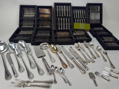 a lot of silver spoons and forks on the table