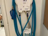 a blue hose attached to the wall of a bathroom