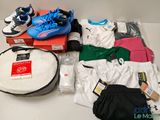 a lot of clothing and shoes on a table