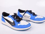 blue and white sneakers with black laces on a white background