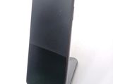 a cell phone that is sitting on top of a stand