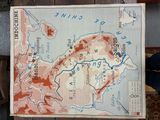 a map of china on a table with a person standing next to it