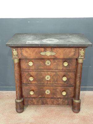 an antique chest of drawers with a marble top and brass handles