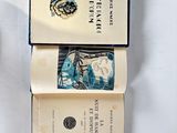 two books that are open on a table