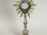 an antique silver and gold chalicet with a cross on top