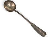 a silver spoon with a spoon handle on a white surface