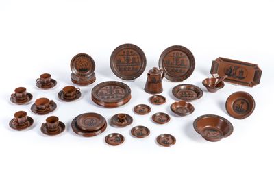 a group of wooden objects including a bowl, plate, and other items