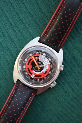 an image of a close up of a wrist watch on a green surface