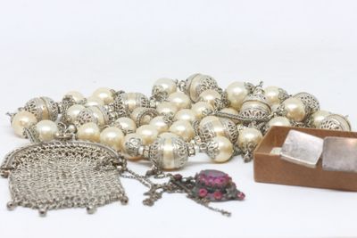 a lot of pearls and other jewelry on a table