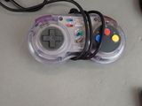 a video game controller sitting on a table next to a keyboard