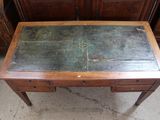 a small wooden table with a metal top on the floor