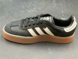 the adidas sneakers are black and white with a light brown sole