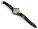 an image of a watch on a white surface with a white background