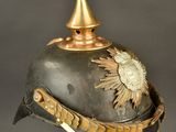 a close up of a helmet on a stand on a gray background