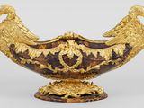 gold and tortoise shell vase with two birds on it