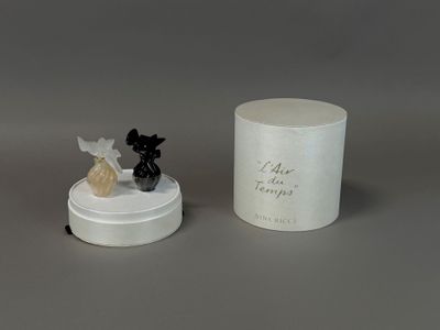 a small figurine of a dog and a candle on a table
