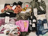 a pile of clothes and shoes on a white table