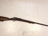 an old rifle is laying on the floor next to a wall