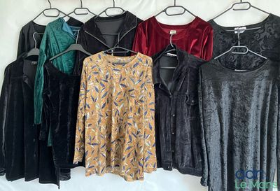 a lot of clothes that are hanging on a clothes rack