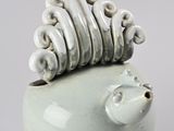 a white pig shaped vase with a spiral design on top of it