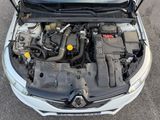 the engine of a car with its hood open in a parking lot
