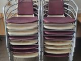 several chairs are stacked on top of each other in a room