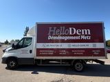 the truck is parked in a parking lot with a sign on it