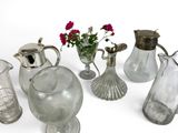 many glass vases and vases with flowers in them