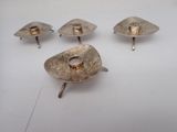 several silver candlesticks with a gold ring on top of them