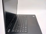 a laptop with a black keyboard on a white surface