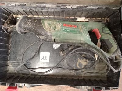 a drill in a box with a cord in it
