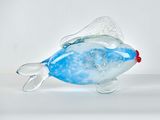 a glass fish that is sitting on a table