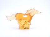 a yellow horse figurine that is on a white surface