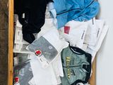 a wooden box filled with clothes on the floor