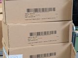 three boxes stacked on top of each other in a warehouse