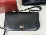 two black and red purses sitting on top of a white table