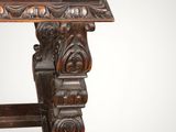an old wooden table with a carved top on a white background