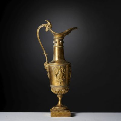 an ornate gold vase with a bird on top of it