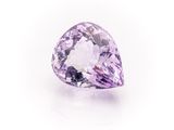 a close up of a purple diamond on a white surface