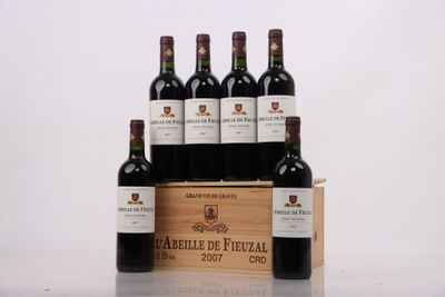 six bottles of red wine in a wooden crate on a table
