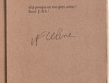 an open book with a handwritten title on the cover