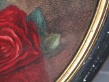 a painting of a red rose in a gold frame